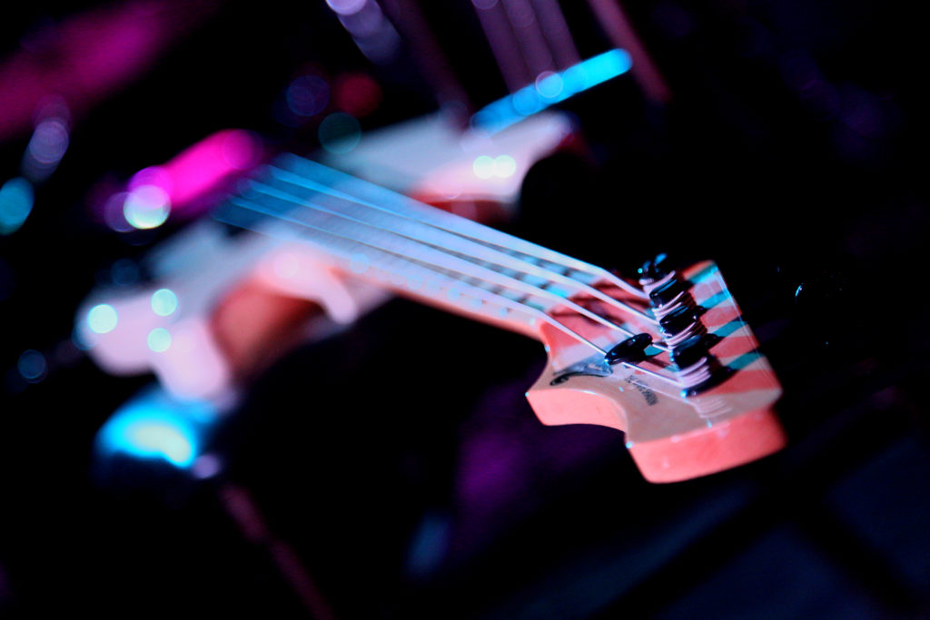 bass guitar with the focus on the neck and tuning pegs