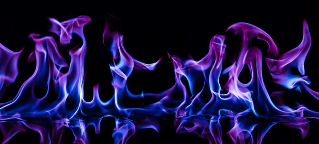 photo of purple and blue flames on a black background