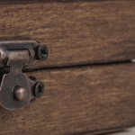 Close-up photo of a wooden box with a metal latch