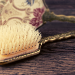 Photo of a vintage brush and the back of a hand mirror