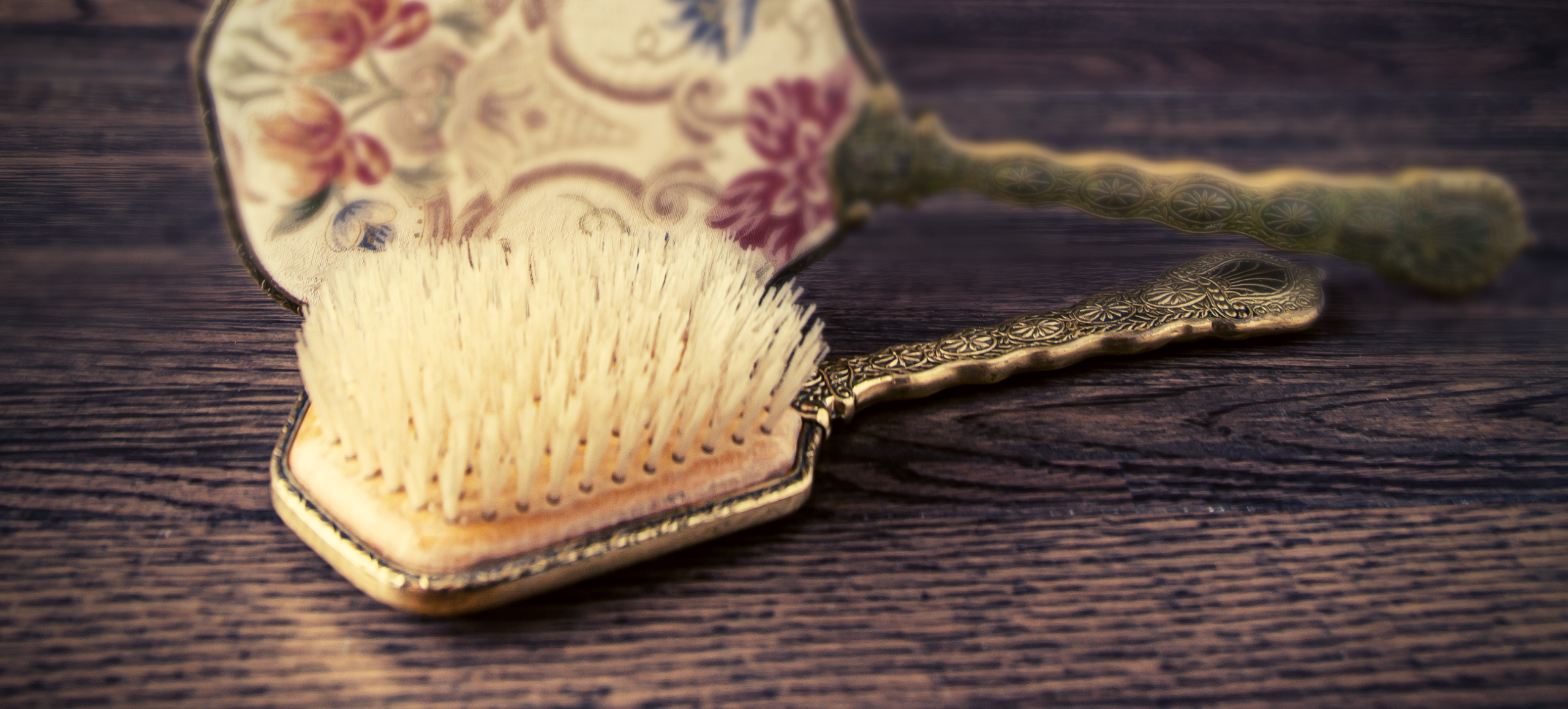 Photo of a vintage brush and the back of a hand mirror