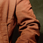 Photo of a person wearing a brown corduroy coat