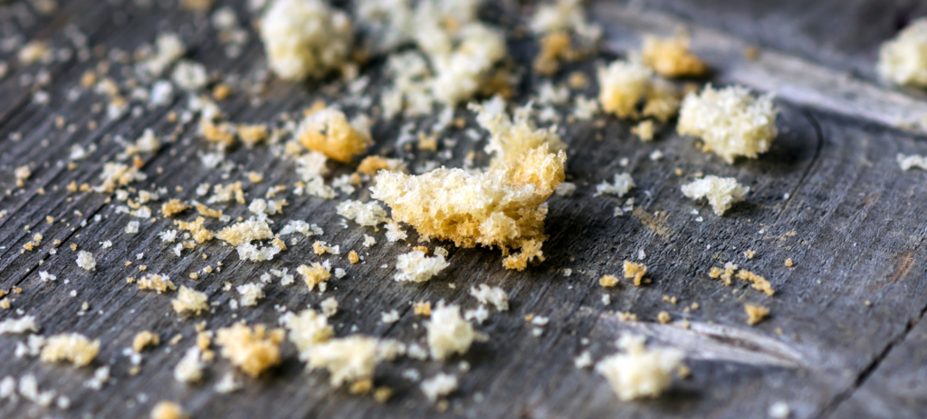 Photo of bread crumbs on a wooden table