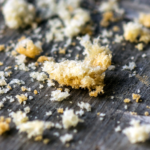 Photo of bread crumbs on a wooden table