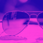 Photo of aviator sunglasses through a bright purple filter