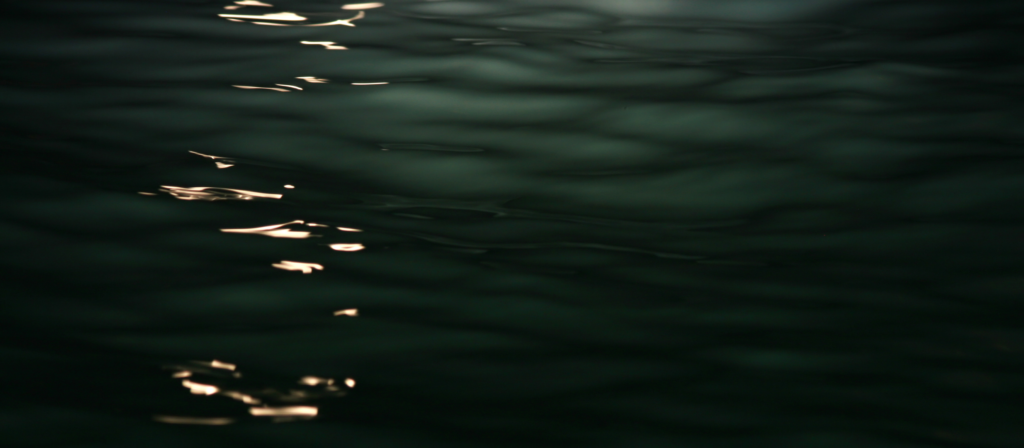 Photo of an eerie light shining on water