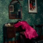 Photo by Foxspit of a woman in a dress lying over a desk