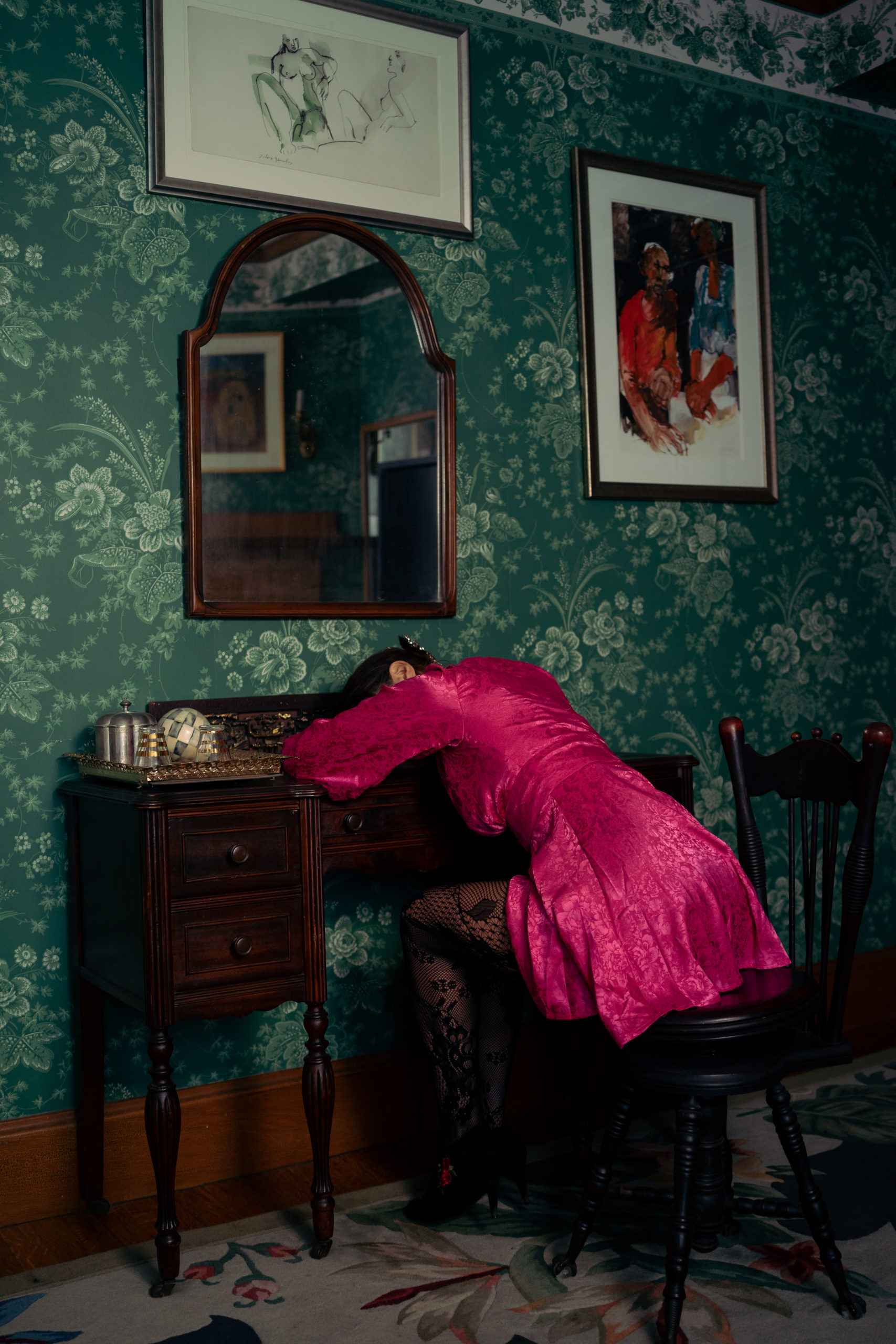 Photo by Foxspit of a woman in a dress lying over a desk